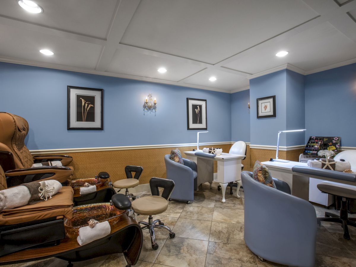 A nail salon interior with pedicure chairs and manicure stations.