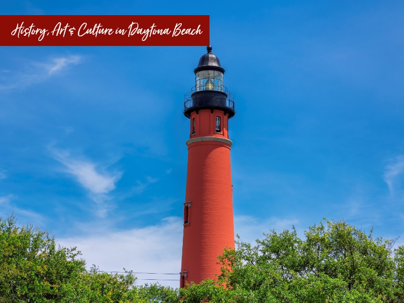 A red lighthouse stands tall against a blue sky with text reading 