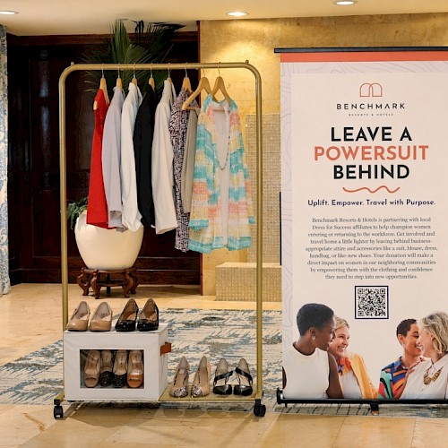A clothing and shoe display next to a sign encouraging women to leave a power suit behind and travel with purpose.