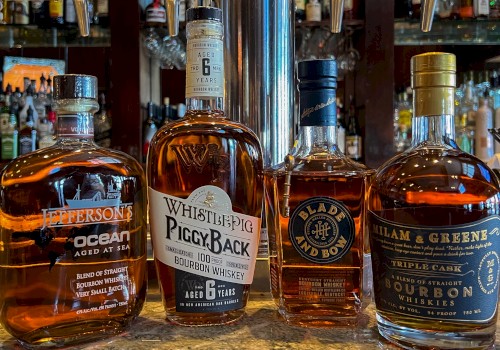 This image shows four bottles of whiskey: Jefferson's Ocean Aged at Sea, WhistlePig PiggyBack, Blade and Bow, and William & Greene.
