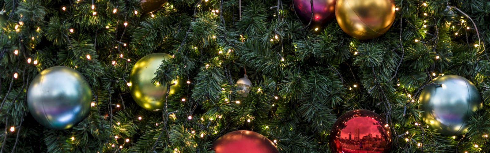 A Christmas tree decorated with colorful ornaments and string lights creates a festive holiday ambiance.