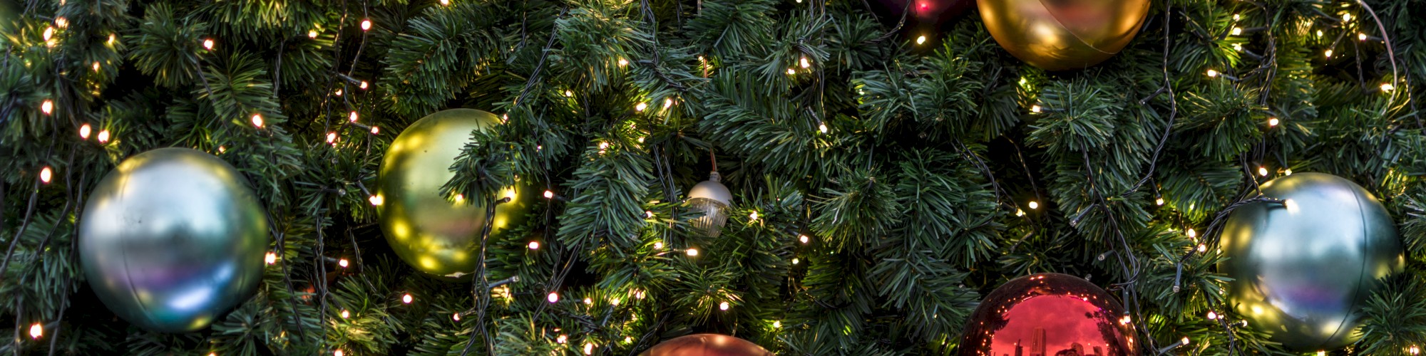 A Christmas tree decorated with colorful ornaments and string lights creates a festive holiday ambiance.